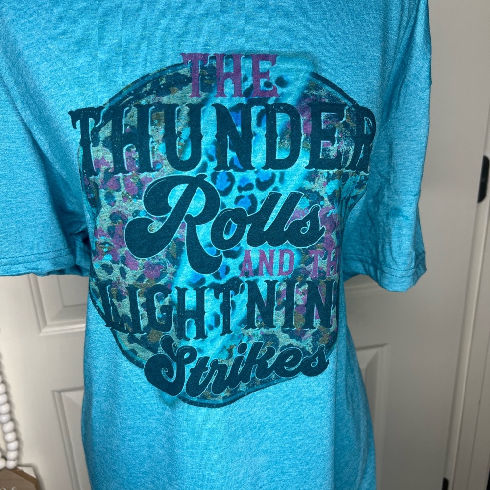 The Thunder Rolls And The Lightning Strikes graphic tee